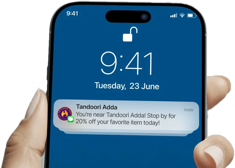 Phone lock screen showing a Tandoori Adda notification: you are nearby, stop by for 20% off